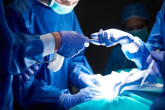 Surgeons passing scissors to each other